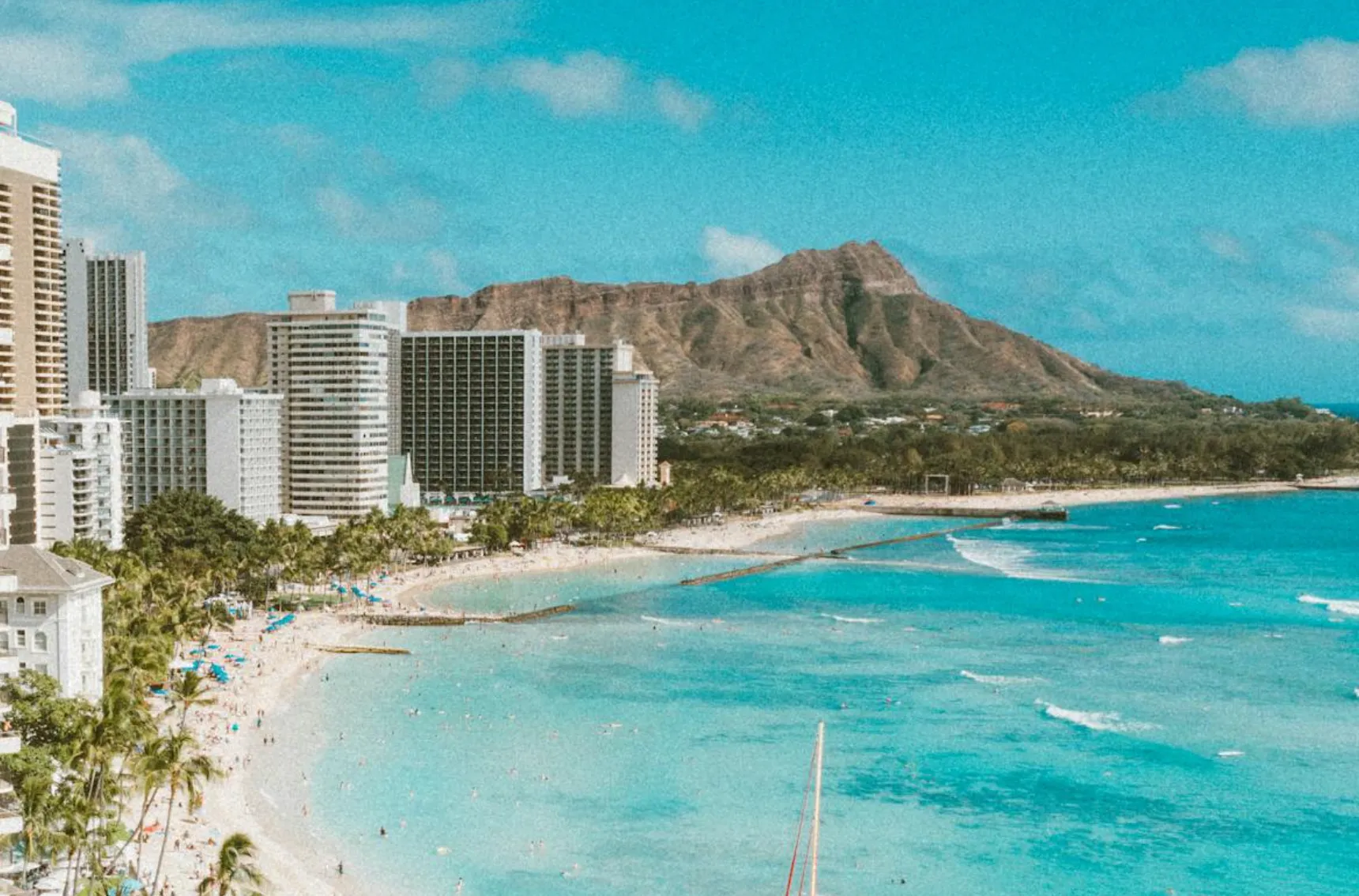 Image: Family on the Diamond Head rim looking back toward Waikīkī at sunrise