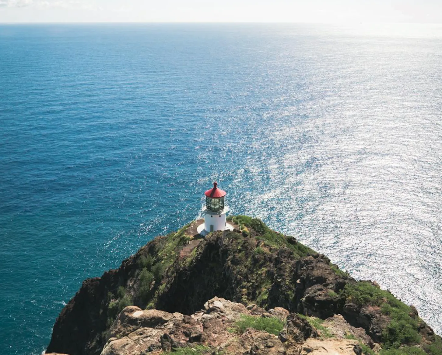 Image: Family walking the paved Makapuʻu Lighthouse Trail, whales breaching offshore in the distance