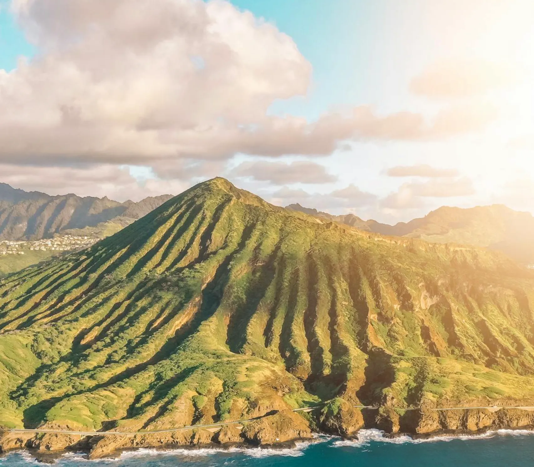 Image: Parent and tween climbing the old railway ties up Koko Crater with the ocean behind