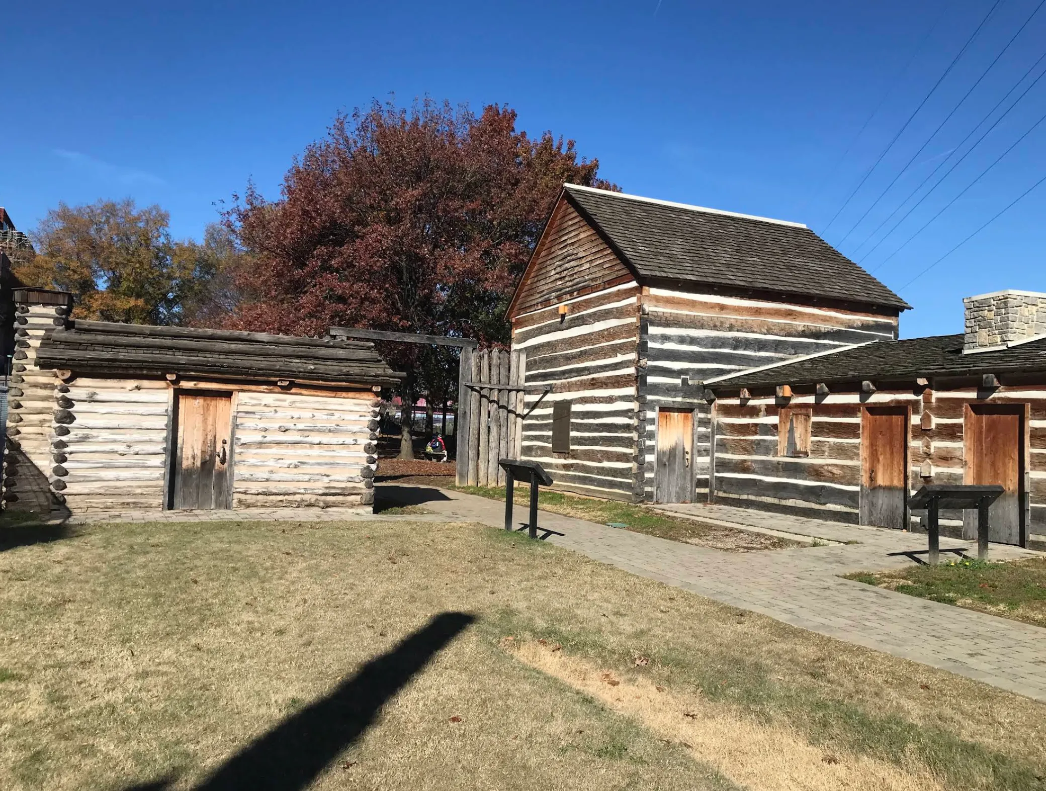 Image: Family standing on the John Seigenthaler Pedestrian Bridge with the Nashville skyline behind them